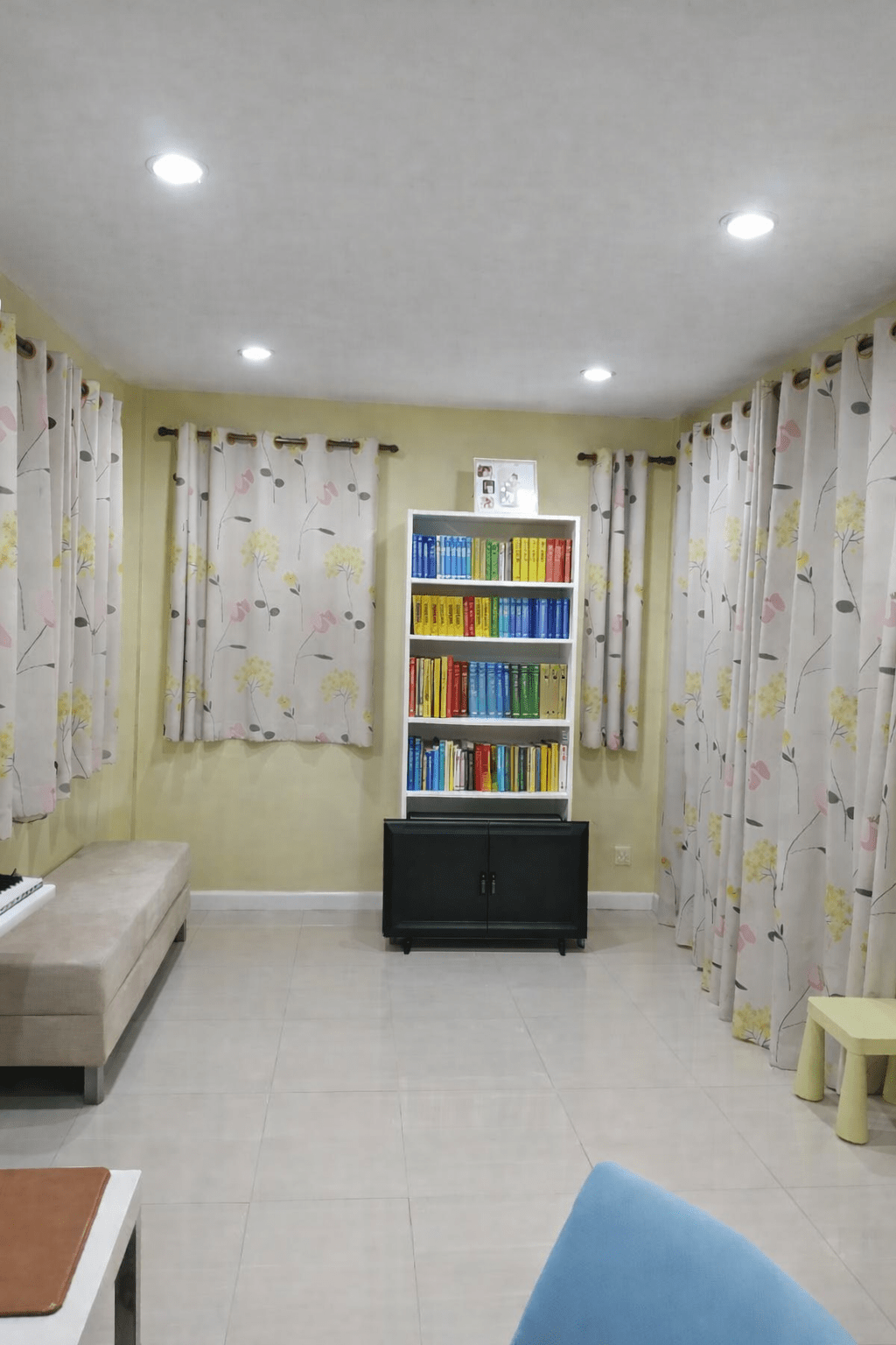 Neatly organized bookshelf in cozy room